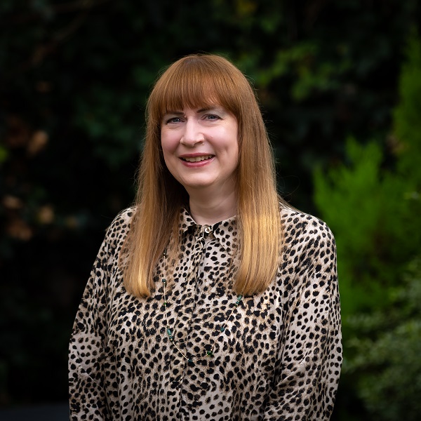 Sharon Ann in leopard print dress in garden in 2022