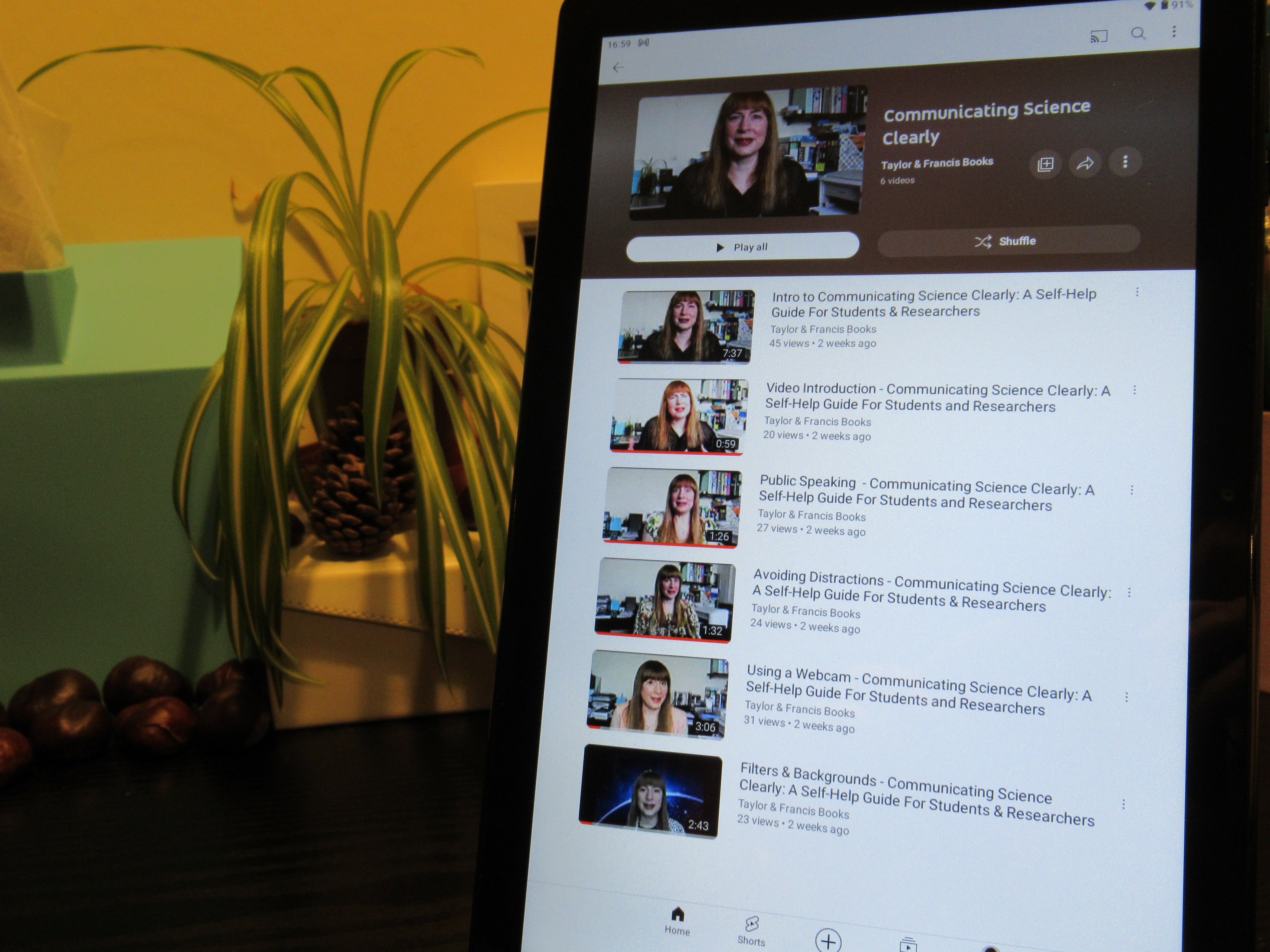Photo of tablet with screen displaying the YouTube playlist for Communicating Science Clearly.