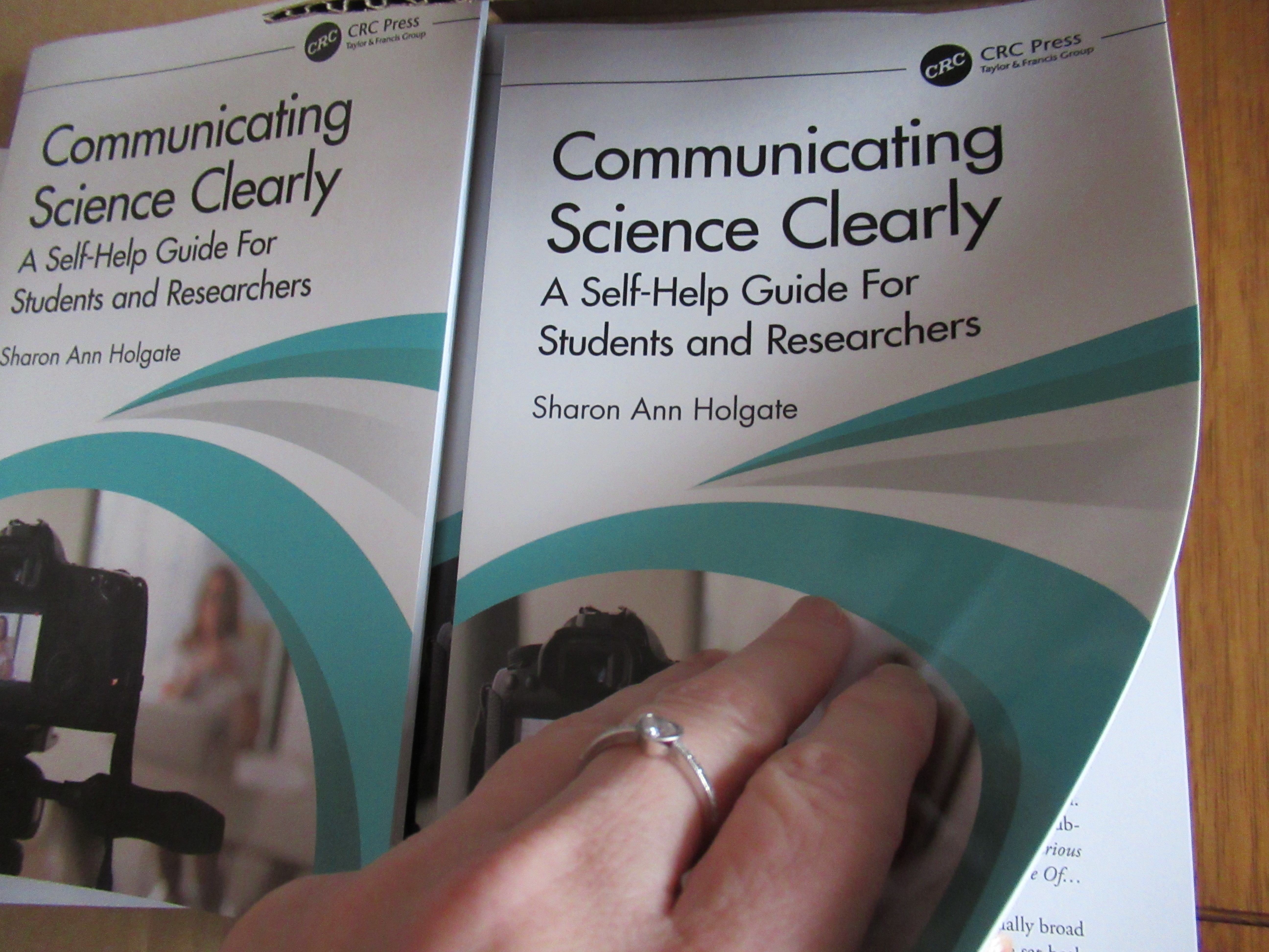 Front covers of two copies of Communicating Science Clearly